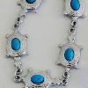 Turquoise cabochons (6x4 mm) in a cute turtle setting. 

14 cm expands to 26 cm

Silver plated