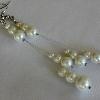 3-strand white glass pearl dangle earrings

Same as previous picture

Shown against a white background