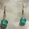 Blue-green with yellow specks Lampwork Glass earrings (23mm drop)

Bead sizes 4mm, 12mm

Silver plated