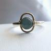6x4mm Blue Chalcedony cabochon set in antiqued Sterling Silver

Ring size 8